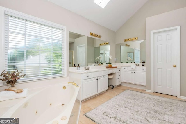 2000 Settindown Dr, Roswell, GA 30075 - bathroom with vaulted ceiling, vanity, a tub with jets, tile patterned flooring, and a skylight