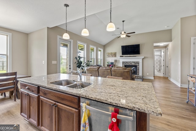 206 Barnyard Way, Perry, GA 31069 - kitchen with stainless steel dishwasher, a fireplace, healthy amount of natural light, ceiling fan, and vaulted ceiling