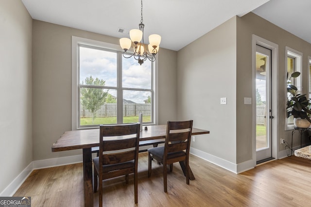 206 Barnyard Way, Perry, GA 31069 - dining room with a chandelier and light wood-style floors