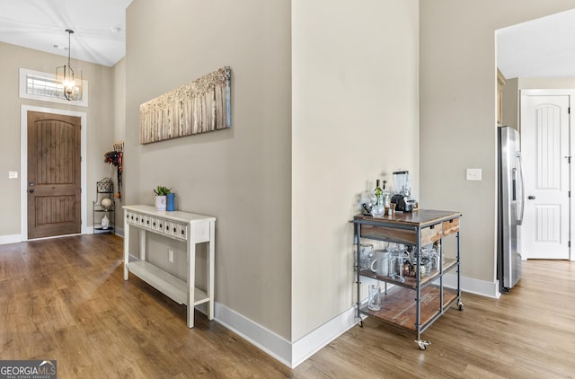 206 Barnyard Way, Perry, GA 31069 - entrance foyer with wood finished floors, a high ceiling, and a chandelier