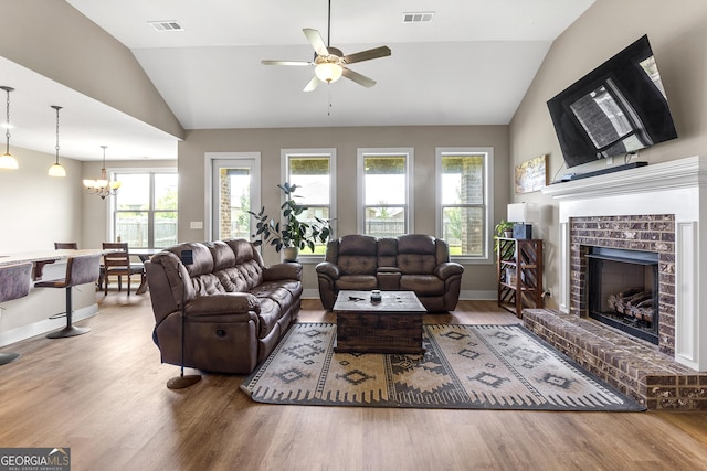206 Barnyard Way, Perry, GA 31069 - living room with vaulted ceiling, wood finished floors, healthy amount of natural light, ceiling fan, and a fireplace