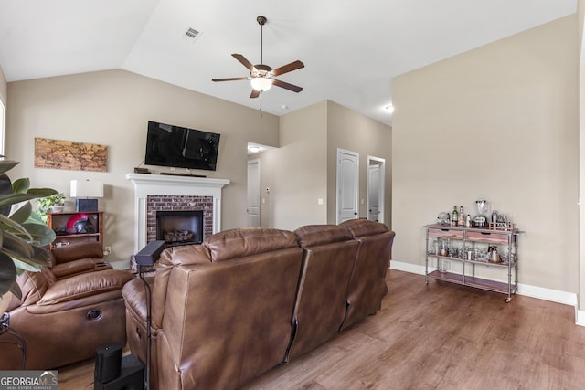 206 Barnyard Way, Perry, GA 31069 - living room with a ceiling fan, a fireplace, wood finished floors, and lofted ceiling