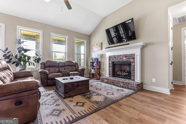 206 Barnyard Way, Perry, GA 31069 - living area with ceiling fan, wood finished floors, lofted ceiling, and a brick fireplace