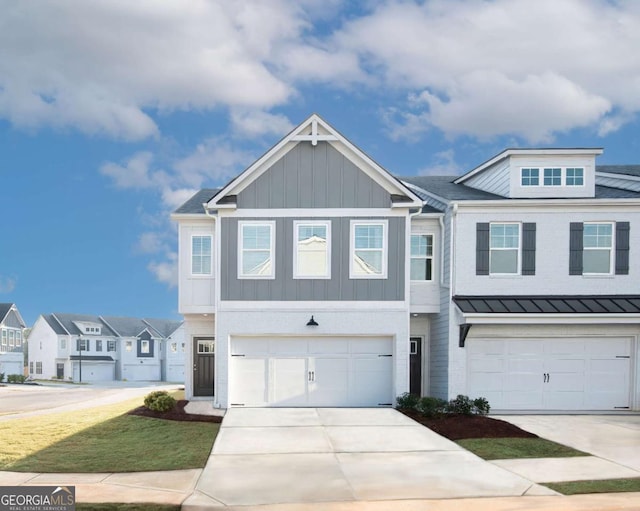 2686 NE Almand Ln NE, Conyers, GA 30013 - townhome / multi-family property with driveway, a garage, board and batten siding, a standing seam roof, and a residential view