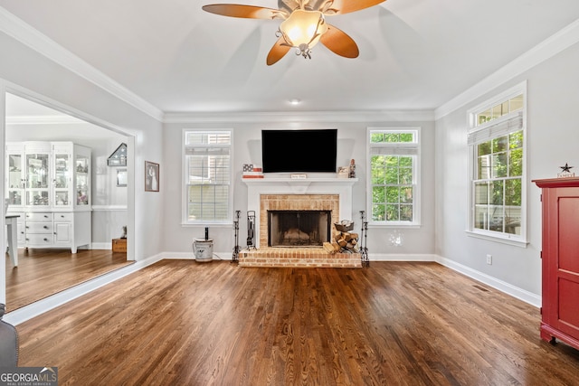 507 Wintergreen Way, Canton, GA 30115 - unfurnished living room featuring a brick fireplace, wood finished floors, a ceiling fan, and crown molding
