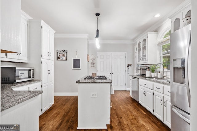 507 Wintergreen Way, Canton, GA 30115 - kitchen featuring appliances with stainless steel finishes, a center island, white cabinets, tasteful backsplash, and ornamental molding