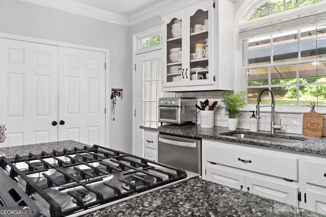 507 Wintergreen Way, Canton, GA 30115 - kitchen with stainless steel dishwasher, cooktop, glass insert cabinets, dark stone counters, and backsplash