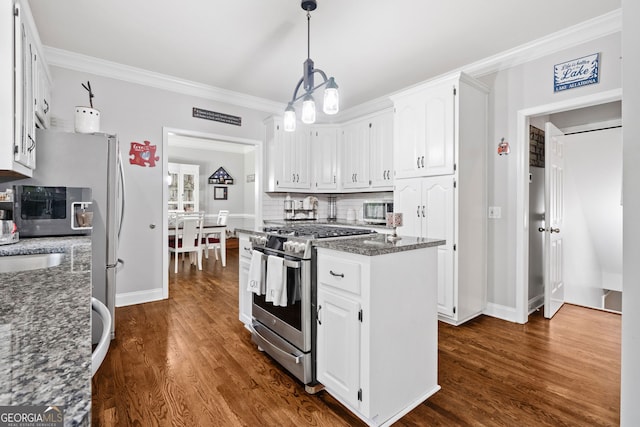 507 Wintergreen Way, Canton, GA 30115 - kitchen with stainless steel gas range, a center island, white cabinetry, dark stone countertops, and crown molding