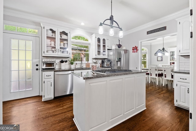 507 Wintergreen Way, Canton, GA 30115 - kitchen with stainless steel appliances, glass insert cabinets, a kitchen island, white cabinetry, and crown molding