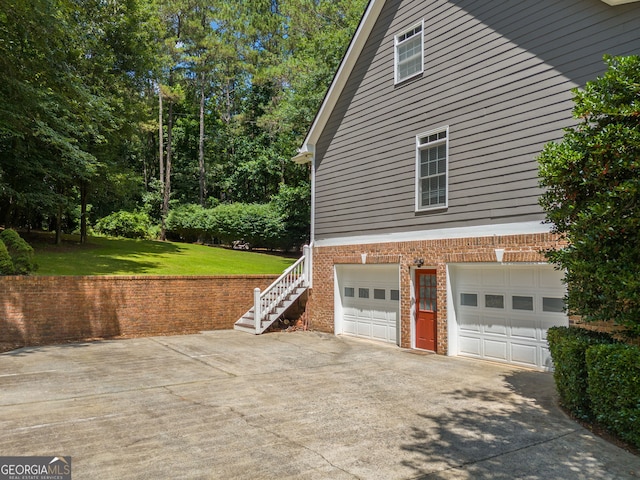 507 Wintergreen Way, Canton, GA 30115 - view of property exterior with an attached garage, a yard, concrete driveway, brick siding, and stairway
