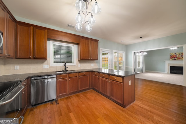 872 Misty View Ct, Lilburn, GA 30047 - kitchen featuring stainless steel appliances, a chandelier, light wood finished floors, and open floor plan