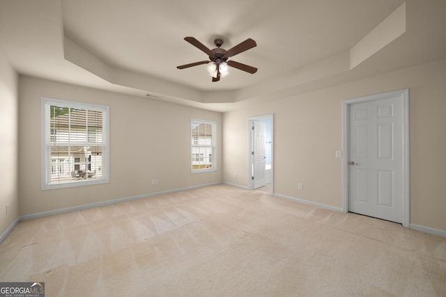 872 Misty View Ct, Lilburn, GA 30047 - unfurnished bedroom featuring a raised ceiling, light colored carpet, and multiple windows