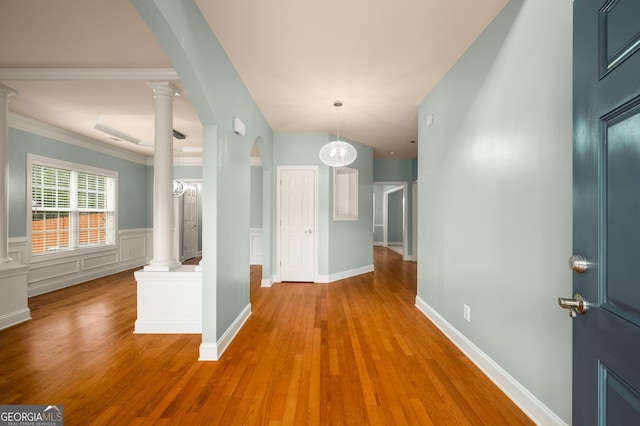 872 Misty View Ct, Lilburn, GA 30047 - hall featuring arched walkways, wood finished floors, decorative columns, and crown molding