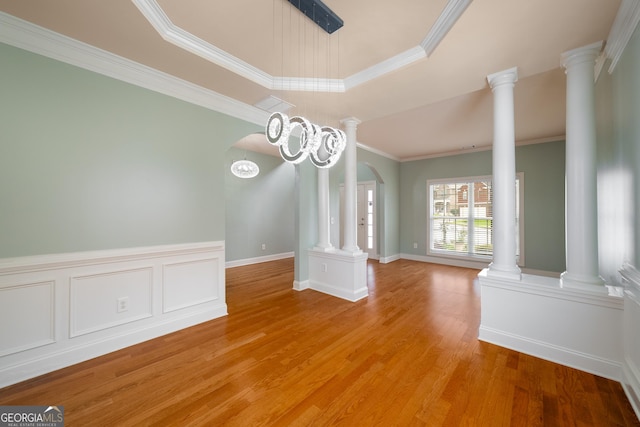 872 Misty View Ct, Lilburn, GA 30047 - unfurnished dining area with arched walkways, crown molding, light wood-type flooring, and decorative columns