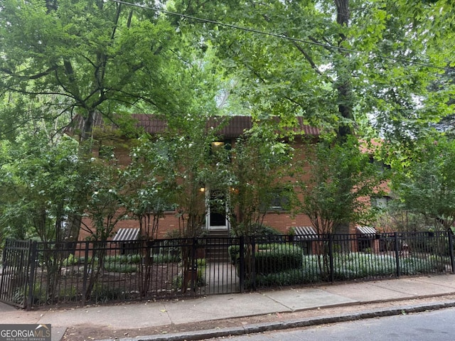 314 3rd St NE Unit 4, Atlanta, GA 30308 - obstructed view of property featuring brick siding and a fenced front yard