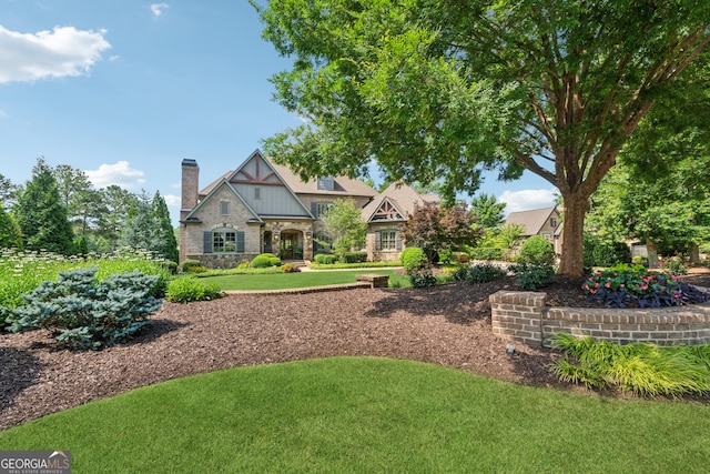 3047 Watsons Bnd, Milton, GA 30004 - tudor house featuring stone siding, a chimney, and a front lawn