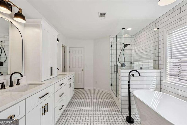 2508 Haddenham Ln SW, Smyrna, GA 30082 - full bath featuring a stall shower, a soaking tub, and double vanity