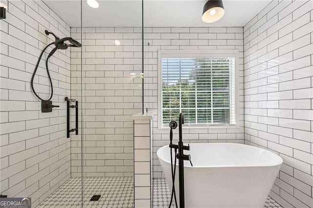2508 Haddenham Ln SW, Smyrna, GA 30082 - bathroom featuring a shower stall, tile walls, and a freestanding bath