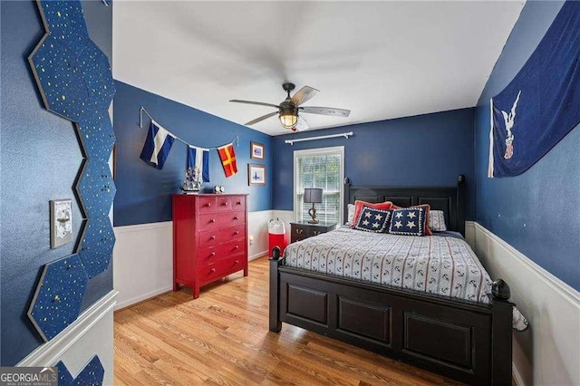 2508 Haddenham Ln SW, Smyrna, GA 30082 - bedroom with wood finished floors, a wainscoted wall, and a ceiling fan