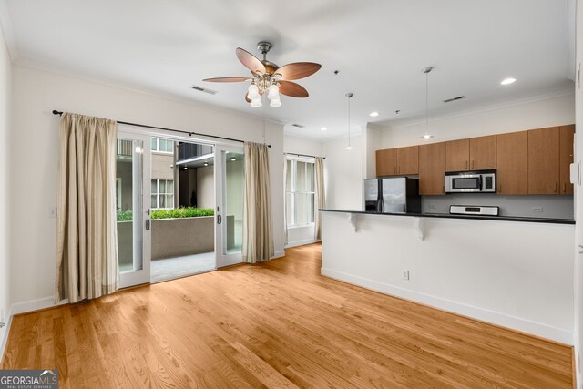 384 Ralph Mcgill Blvd NE Unit 123, Atlanta, GA 30312 - kitchen with appliances with stainless steel finishes, brown cabinets, dark countertops, ceiling fan, and hanging light fixtures