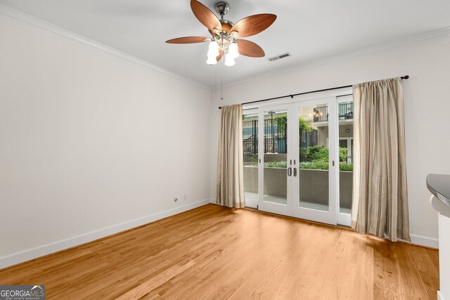 384 Ralph Mcgill Blvd NE Unit 123, Atlanta, GA 30312 - empty room featuring wood finished floors, a ceiling fan, crown molding, and french doors