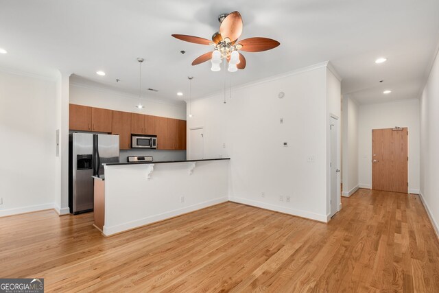 384 Ralph Mcgill Blvd NE Unit 123, Atlanta, GA 30312 - kitchen with appliances with stainless steel finishes, a peninsula, brown cabinetry, a ceiling fan, and recessed lighting