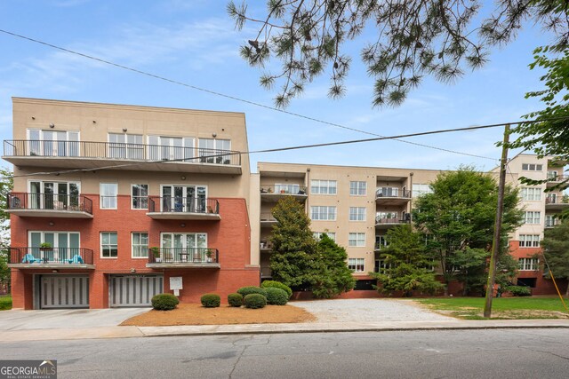 384 Ralph Mcgill Blvd NE Unit 123, Atlanta, GA 30312 - view of apartment building / complex featuring concrete driveway and an attached garage