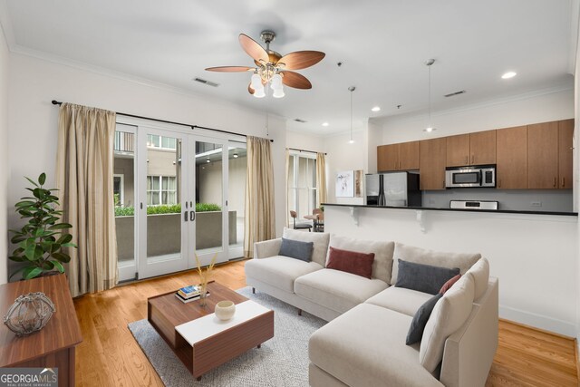 384 Ralph Mcgill Blvd NE Unit 123, Atlanta, GA 30312 - living area featuring french doors, healthy amount of natural light, a ceiling fan, light wood-style floors, and crown molding