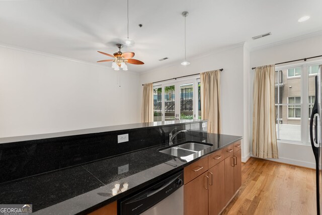 384 Ralph Mcgill Blvd NE Unit 123, Atlanta, GA 30312 - kitchen with stainless steel dishwasher, crown molding, plenty of natural light, light wood-style flooring, and dark stone counters