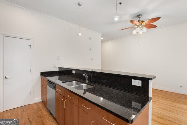 384 Ralph Mcgill Blvd NE Unit 123, Atlanta, GA 30312 - kitchen with a peninsula, ornamental molding, stainless steel dishwasher, light wood-style flooring, and brown cabinets