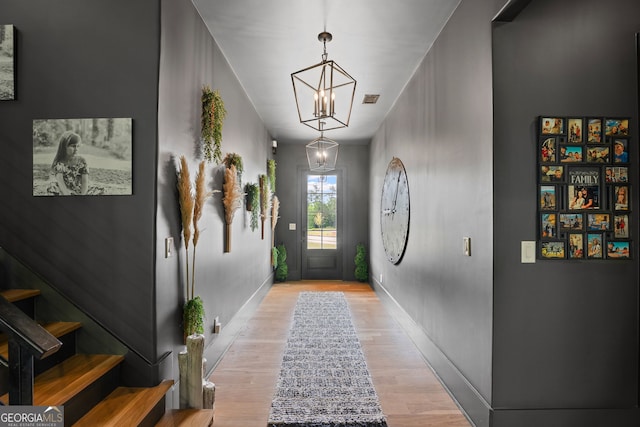 40 Fernbank Way, Newnan, GA 30265 - doorway featuring a chandelier, light wood finished floors, and stairs