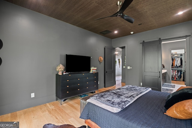 40 Fernbank Way, Newnan, GA 30265 - bedroom featuring a barn door, wood finished floors, recessed lighting, a spacious closet, and ceiling fan