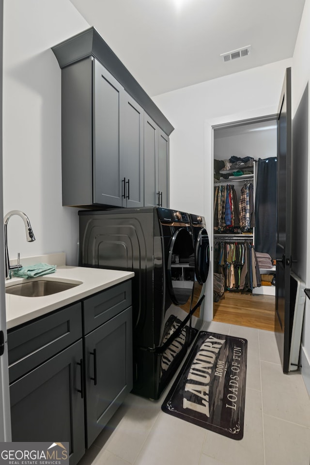 40 Fernbank Way, Newnan, GA 30265 - washroom with washer and clothes dryer, cabinet space, and light tile patterned floors