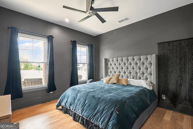 40 Fernbank Way, Newnan, GA 30265 - bedroom with multiple windows, wood finished floors, and ceiling fan
