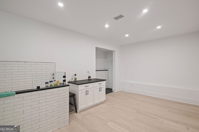 40 Fernbank Way, Newnan, GA 30265 - kitchen with dark countertops, white cabinetry, light wood-style floors, and recessed lighting