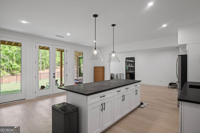 40 Fernbank Way, Newnan, GA 30265 - kitchen featuring dark countertops, light wood-type flooring, white cabinetry, recessed lighting, and hanging light fixtures