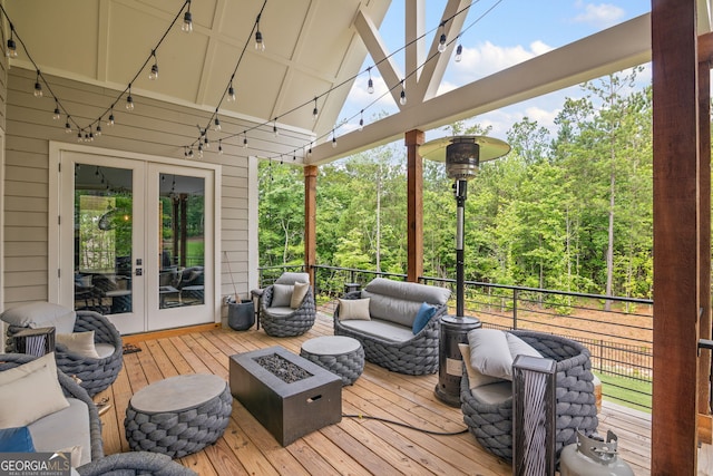 40 Fernbank Way, Newnan, GA 30265 - deck with french doors, an outdoor living space with a fire pit, and a wooded view