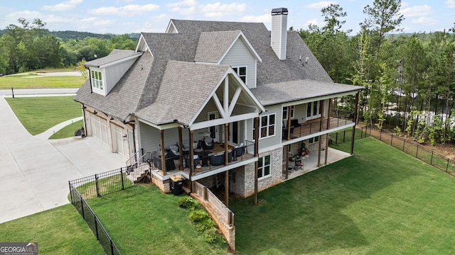 40 Fernbank Way, Newnan, GA 30265 - rear view of property with concrete driveway, roof with shingles, a chimney, a fenced backyard, and a garage