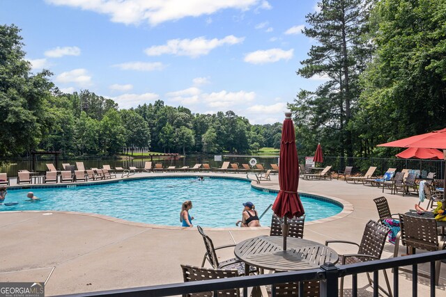 40 Fernbank Way, Newnan, GA 30265 - community pool featuring a patio area and view of wooded area