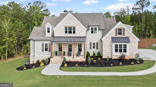 40 Fernbank Way, Newnan, GA 30265 - modern farmhouse style home with a standing seam roof, covered porch, board and batten siding, a chimney, and a front yard