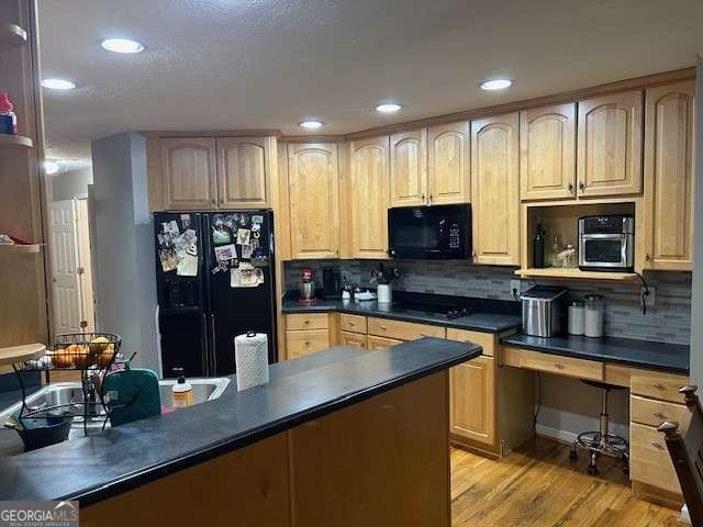 370 Butler Path, Dallas, GA 30132 - kitchen with black appliances, light brown cabinets, dark countertops, light wood-type flooring, and recessed lighting