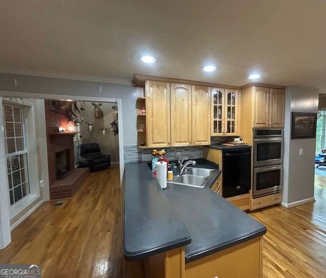 370 Butler Path, Dallas, GA 30132 - kitchen featuring stainless steel double oven, dishwasher, dark countertops, light brown cabinets, and light wood-style floors