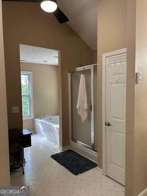 370 Butler Path, Dallas, GA 30132 - bathroom with a bath, a shower stall, vaulted ceiling, and a ceiling fan