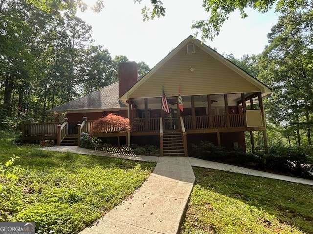 370 Butler Path, Dallas, GA 30132 - view of front of house featuring a chimney, a sunroom, a front yard, a deck, and a ceiling fan