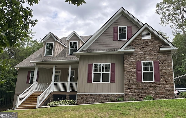 48 Narrow Ln, Dahlonega, GA 30533 - craftsman-style house featuring stone siding, a porch, a front lawn, and roof with shingles