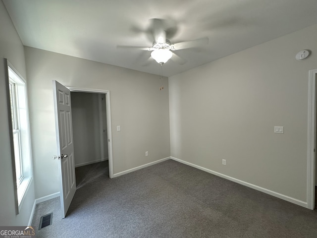48 Narrow Ln, Dahlonega, GA 30533 - unfurnished bedroom with dark colored carpet and a ceiling fan