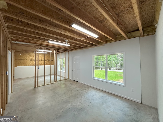 48 Narrow Ln, Dahlonega, GA 30533 - spare room featuring unfinished concrete floors and plenty of natural light