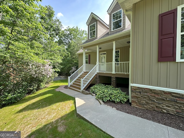 48 Narrow Ln, Dahlonega, GA 30533 - entrance to property with covered porch, board and batten siding, a lawn, and stone siding