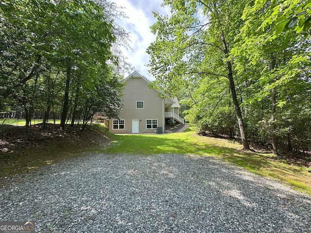 48 Narrow Ln, Dahlonega, GA 30533 - view of side of home featuring stairway, gravel driveway, and a lawn