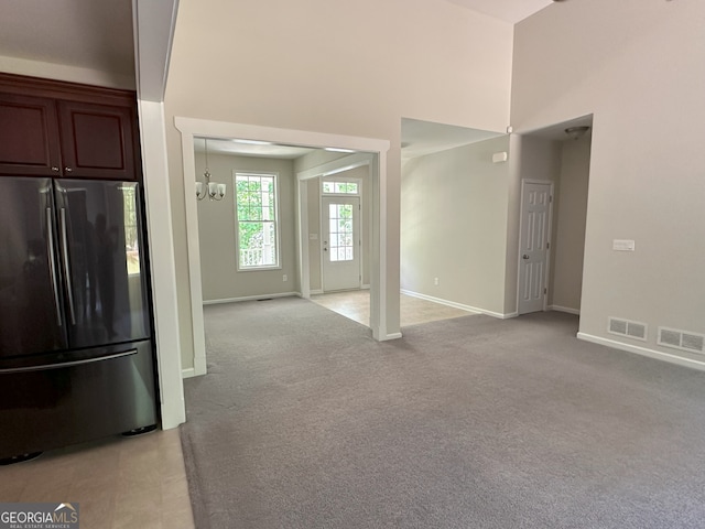48 Narrow Ln, Dahlonega, GA 30533 - kitchen with freestanding refrigerator, a chandelier, light colored carpet, and a high ceiling